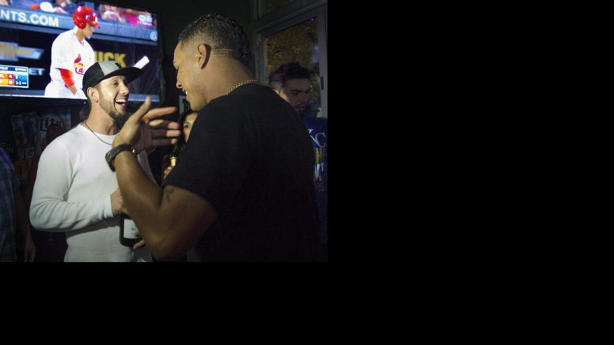 
Kansas City Royals players James Shields (left) and Salvador Perez laugh while celebrating on Wednesday, Oct. 15, at McFadden's Sports Saloon in Kansas City Power & Light District in downtown Kansas City. The Kansas City Royals beat the Baltimore Orioles, 2-1, in game four of the American League Championship Series on the big screen at The Royals won the American League pennant and earn a trip to the World Series.
