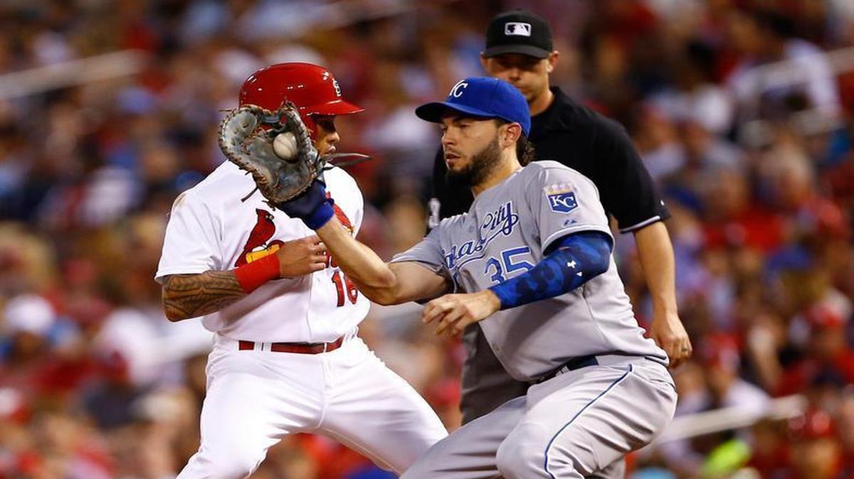 
The Cardinals' Kolten Wong (left) gets back to first base safely ahead of the tag by Royals first baseman Eric Hosmer during the fifth inning of Friday’s baseball game in St. Louis.
