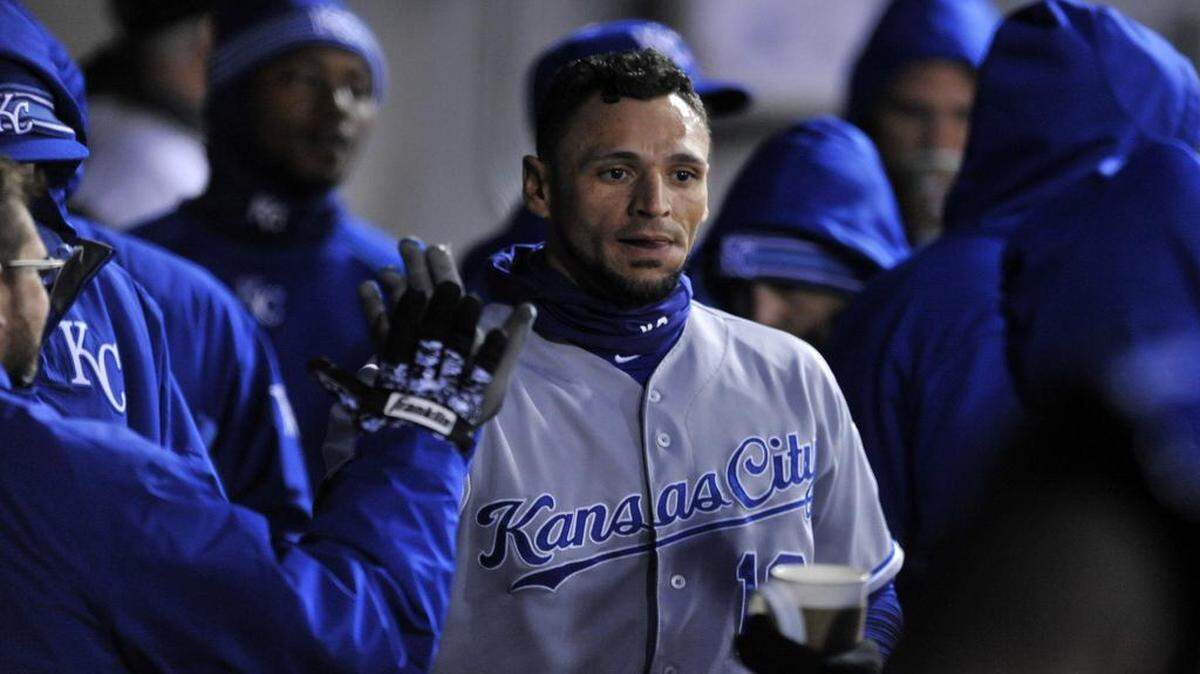 
Kansas City Royals' Paulo Orlando celebrates with teammates in the dugout after scoring on a Alcides Escobar single during the third inning of their game against the Chicago White Sox on Friday, April 24, 2015, in Chicago. (AP Photo/Paul Beaty)

