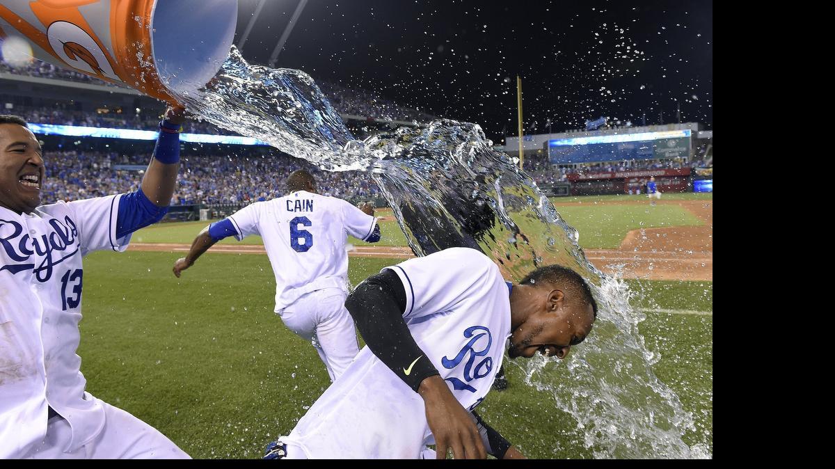 
Salvador Perez (left) dumped the water bucket on Jarrod Dyson as Lorenzo Cain ran away after the Royals’ 3-2, 10-inning win over the Minnesota Twins on Friday night.
