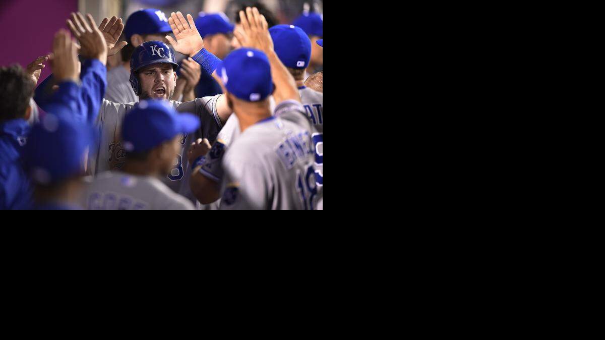 
Kansas City Royals third baseman Mike Moustakas (8) received congratulations on scoring in the third inning on an RBI double by Alcides Escobar against the Los Angeles Angels during Thursday's ALDS baseball game on October 2, 2014 at Angels Stadium in Anaheim, Calif.
