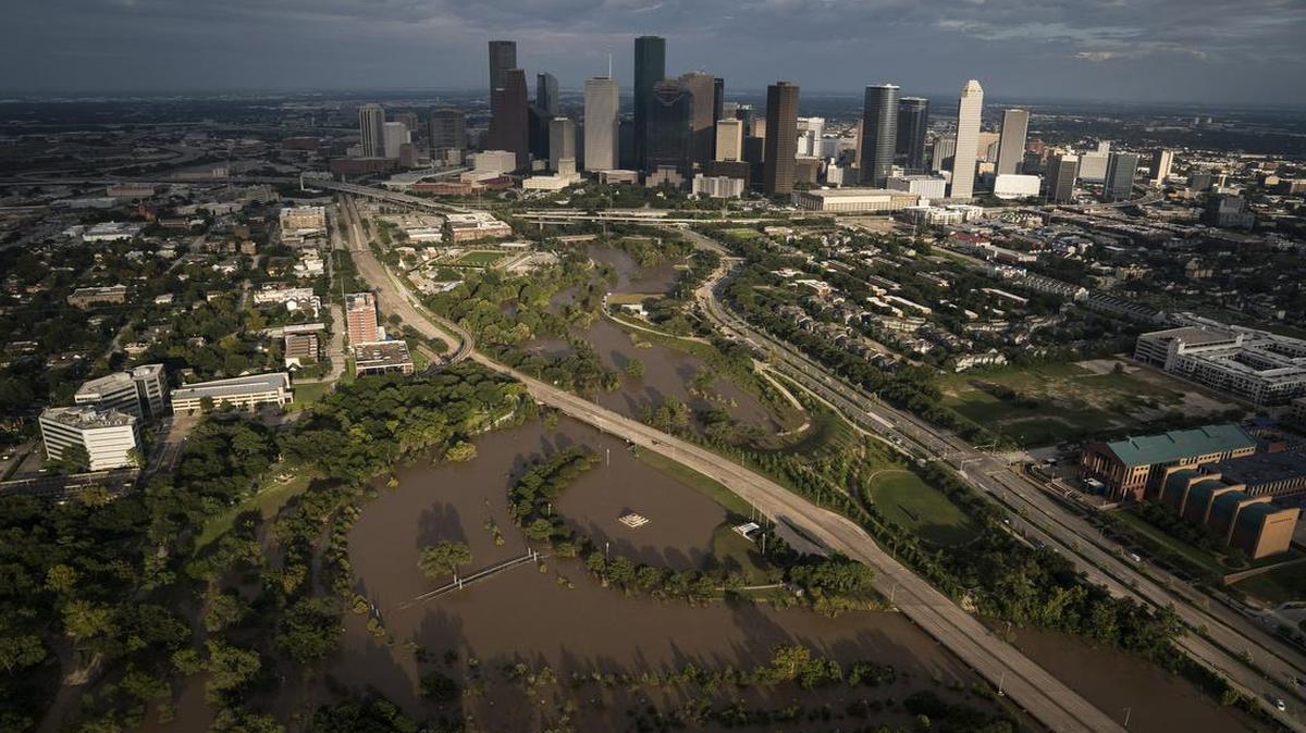 The sun sets on downtown Houston as flood waters still surround some neighborhoods.