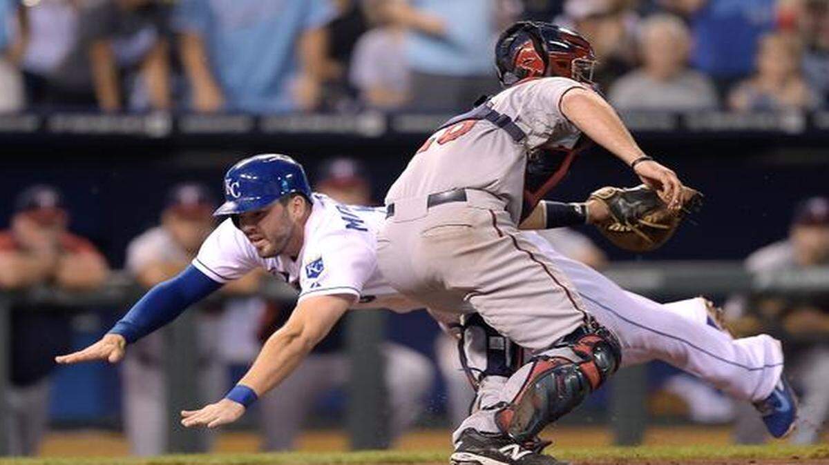 
The Royals' Mike Moustakas scores before the tag from Twins catcher Eric Fryer on a triple by Alcides Escobar during Thursday's baseball game at Kauffman Stadium.

