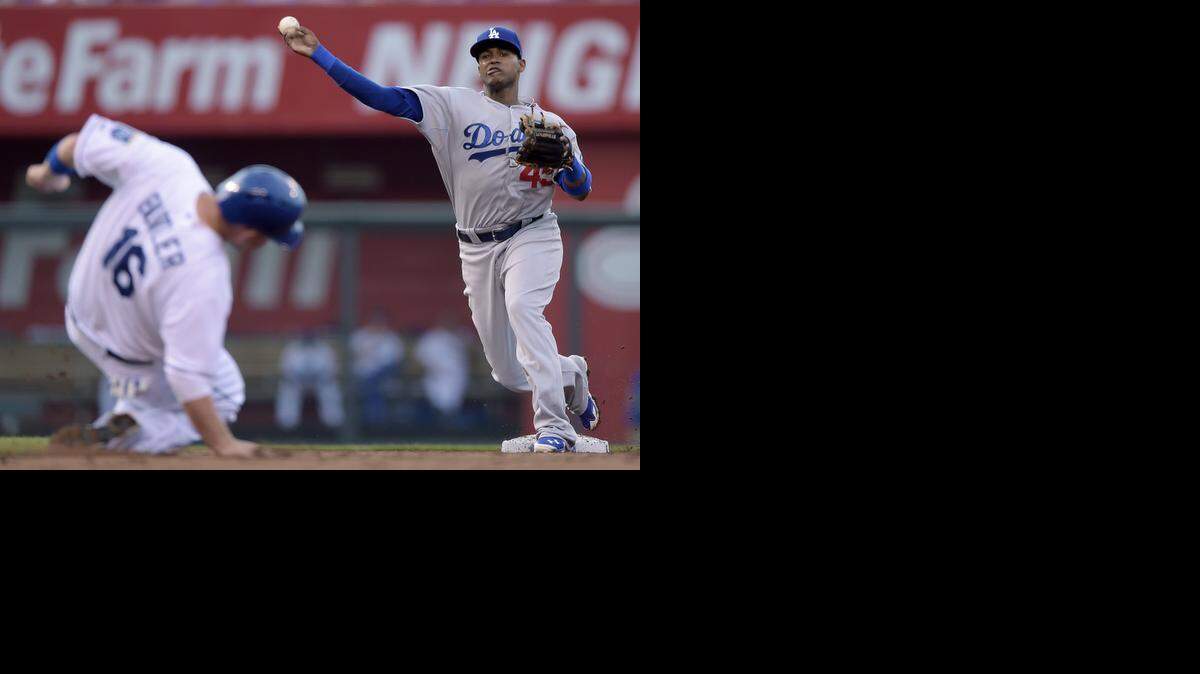 
Kansas City Royals' Billy Butler (16) ducks out of the way as Los Angeles Dodgers shortstop Carlos Triunfel (45) completes the double play on Alex Gordon to end the third inning during Monday's baseball game on June 23, 2014 at Kauffman Stadium in Kansas City, Mo.
