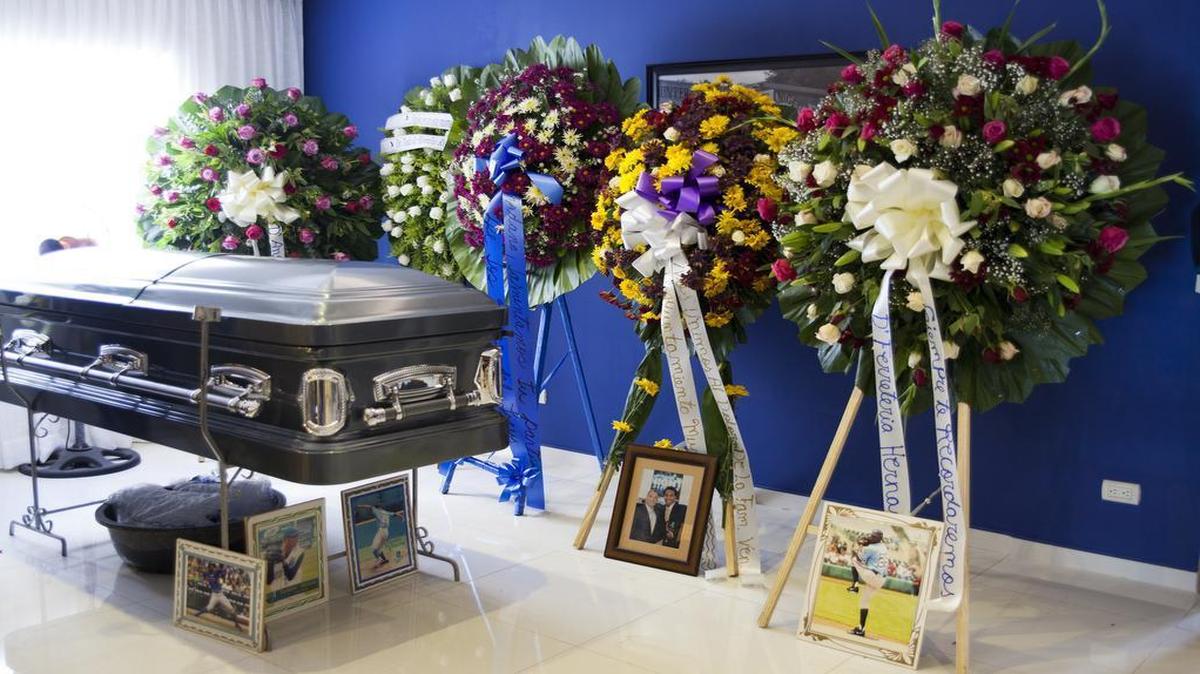 The coffin containing the remains of Kansas City Royals pitcher Yordano Ventura is surrounded by funeral wreaths and images of the major-league player, in the living room of one his two homes, in Las Terrenas, Dominican Republic, Monday, Jan. 23, 2017. (AP Photo/Tatiana Fernandez)