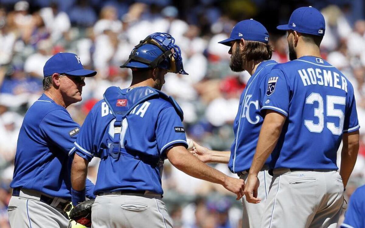 Royals manager Ned Yost (left) took the ball from starter Jason Hammel (second from right) as Drew Butera (9) and Eric Hosmer (35) stood by in the fourth inning of Sunday’s game against the Rangers in Arlington, Texas. The Royals lost the game 5-2.