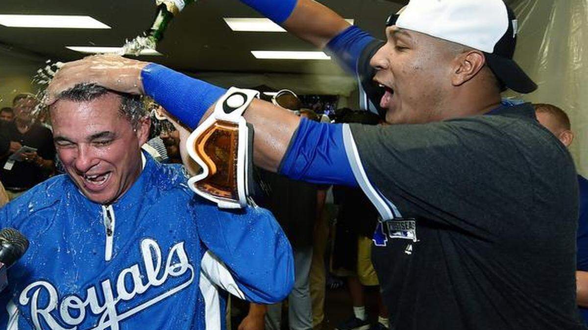
Kansas City Royals general manager Dayton Moore was doused by Salvador Perez in the celebration after the team clinched a playoff spot Friday at U.S. Cellular Field in Chicago.
