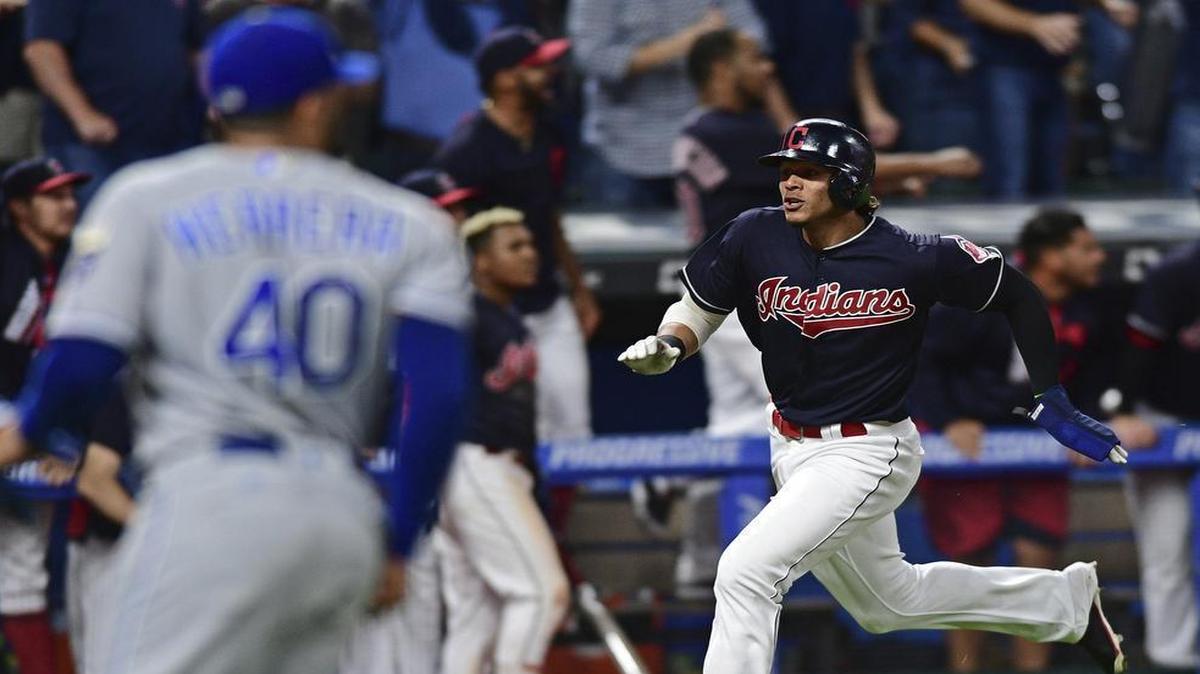 Cleveland’s Erik Gonzalez (right) scored the tying run in the ninth on a double by Francisco Lindor. The hit was given up by Royals reliever Kelvin Herrera (left). Cleveland has won 22 consecutive games.