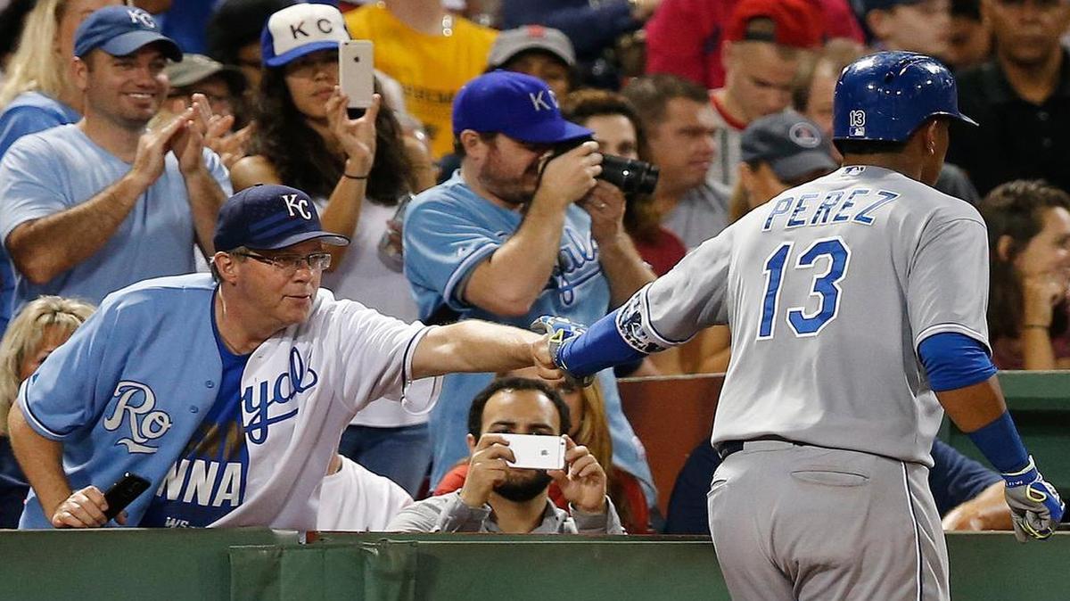 
Salvador Perez (13) celebrated his three-run home run with a Royals fan in the sixth inning against the Red Sox on Saturday night in Boston.
