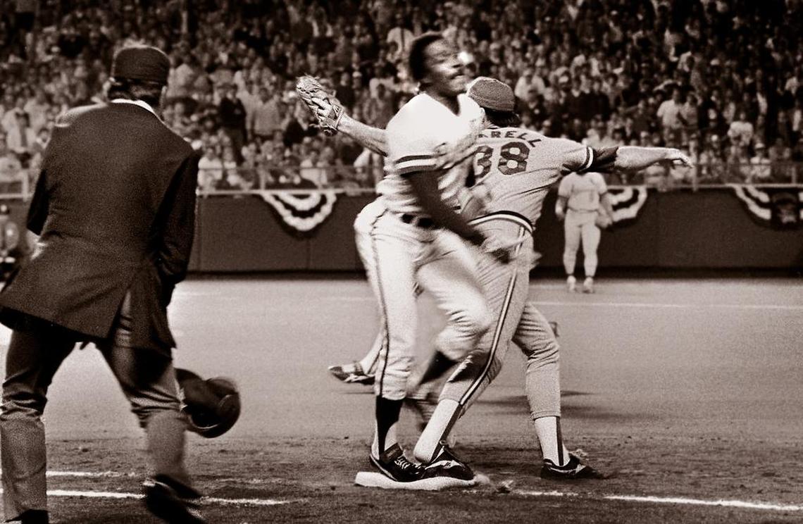 With umpire Don Denkinger (left) watching, the Cardinals’ Todd Worrell stretched and caught the ball right before Jorge Orta’s foot touched first base in Game 6 of the 1985 World Series. The blown call helped the Royals win and forced a Game 7, in which they defeated the Cardinals and became world champions for the first time.