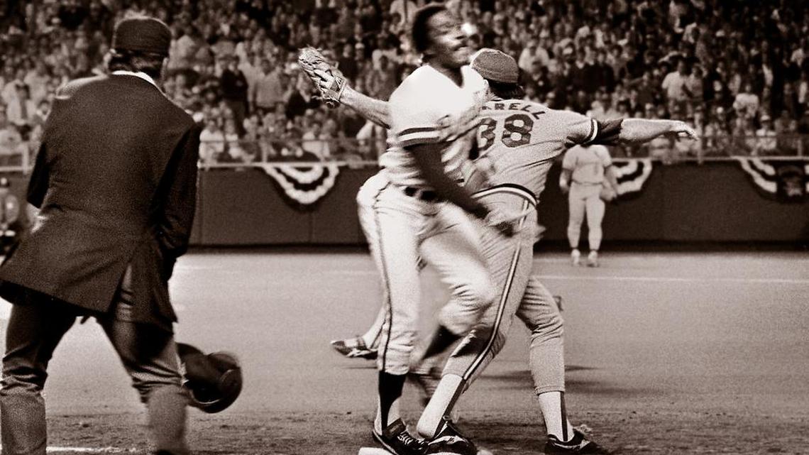 With umpire Don Denkinger (left) watching, the Cardinals’ Todd Worrell stretched and caught the ball right before Jorge Orta’s foot touched first base in Game 6 of the 1985 World Series. The blown call helped the Royals win and forced a Game 7, in which they defeated the Cardinals and became world champions for the first time.