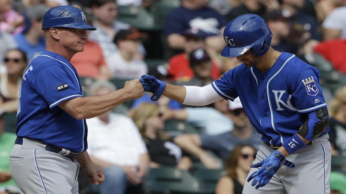 Kansas City Royals second baseman Whit Merrifield (right) celebrated with third-base coach Mike Jirschele after hitting a two-RBI triple against the Chicago White Sox during the sixth inning of Sunday’s game.