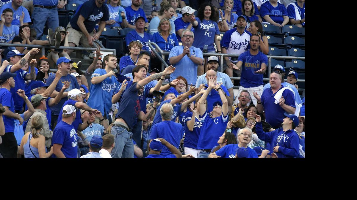 
Fans try to catch a foul ball off the bat of Royals designated hitter Kendrys Morales a game against the Indians earlier this month at Kauffman Stadium.
