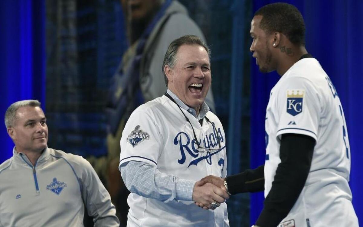 A happy Kansas City Royals manager Ned Yost shook hands with Royals shortstop Alcides Escobar as general manager Dayton Moore looked on during last year’s FanFest.