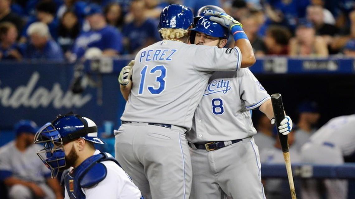 The Royals’ Salvador Perez (left) hugged Mike Moustakas after Perez hit a two-run home run in the second inning of Wednesday’s game against the Blue Jays in Toronto. Moustakas got a chance to celebrate his own homer in the sixth inning that broke Steve Balboni’s franchise record of 36 in a season.