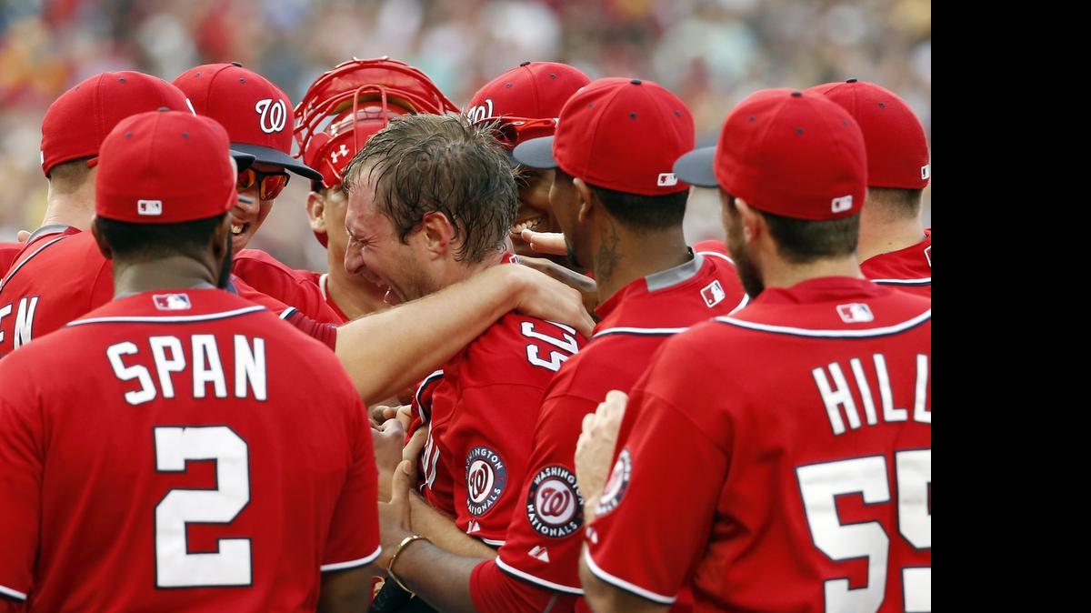 
Washington Nationals starting pitcher Max Scherzer, center, celebrates with teammates after his no-hitter baseball game against the Pittsburgh Pirates, Saturday, June 20, 2015, in Washington. The Nationals won 6-0.
