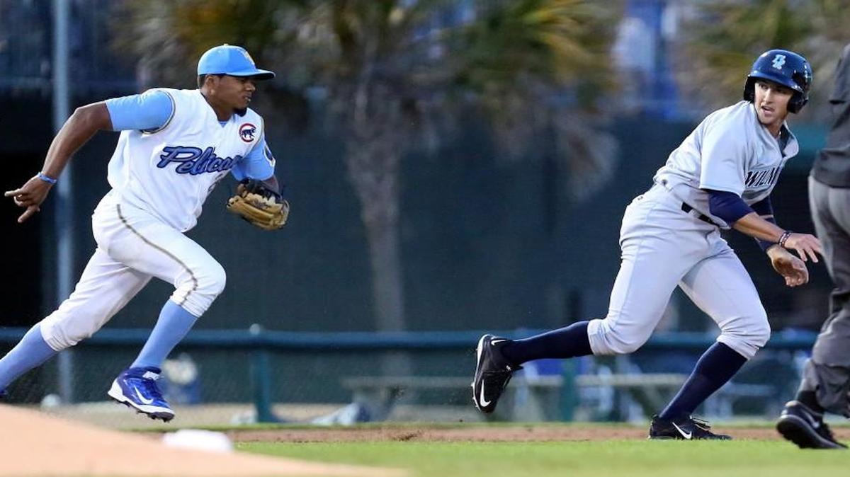 Myrtle Beach’s Jeimer Candelario chases down and tags Wilmington’s Daniel Rockett on April 9, 2015.