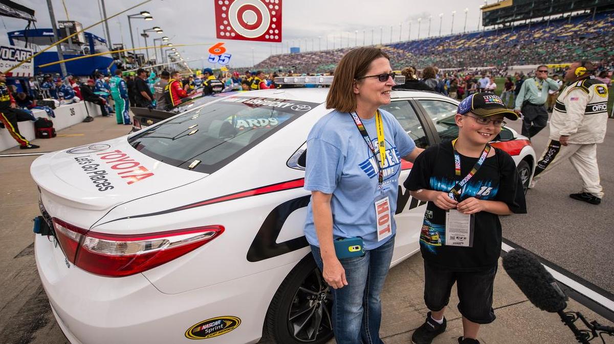 Tina Gramkow, center, and her son, Dalton Gramkow, 10, both of Avon, S.D., won a ride in the official pace car before the SpongeBob SquarePants 400.