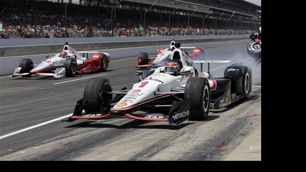 
Will Power, of Australia, (1) beats teammate Simon Pagenaud, of France, (22) and Juan Pablo Montoya, of Colombia, out of the pit area after pits stops during the 99th running of the Indianapolis 500 auto race at Indianapolis Motor Speedway in Indianapolis, Sunday, May 24, 2015. 
