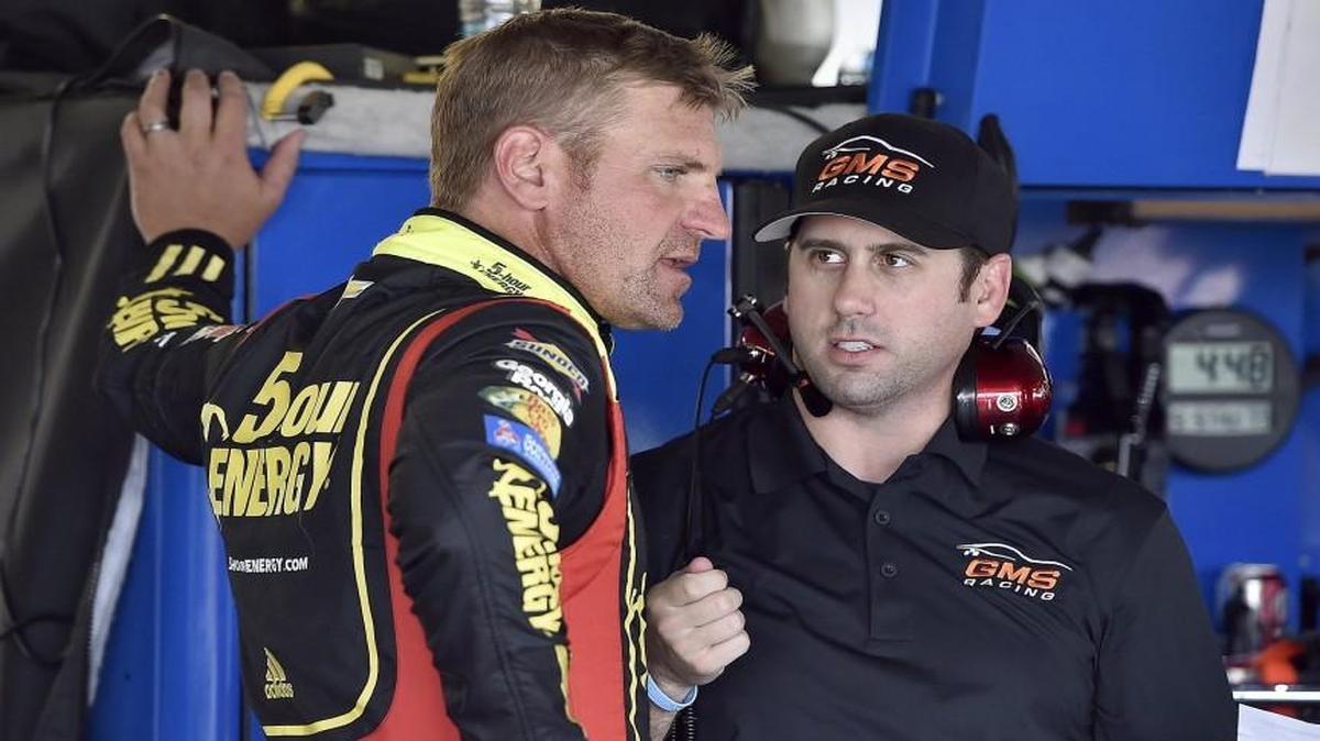 Clint Bowyer (left) talked with a crew member during the second practice run at Kansas Speedway on Thursday, May 5, 2016.