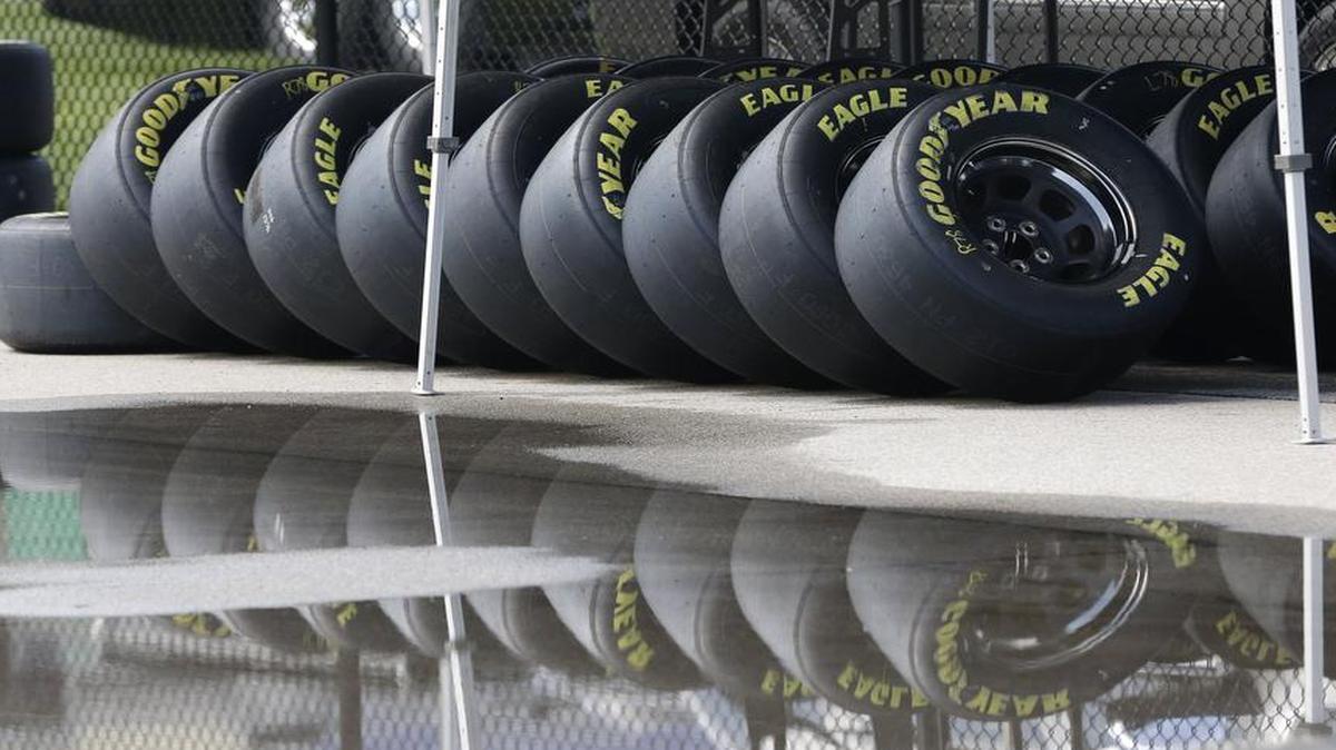 
Race tires were stacked next to a rain puddle at Kansas Speedway in Kansas City, Kan., on Thursday. Wet weather is expected over the weekend. 
