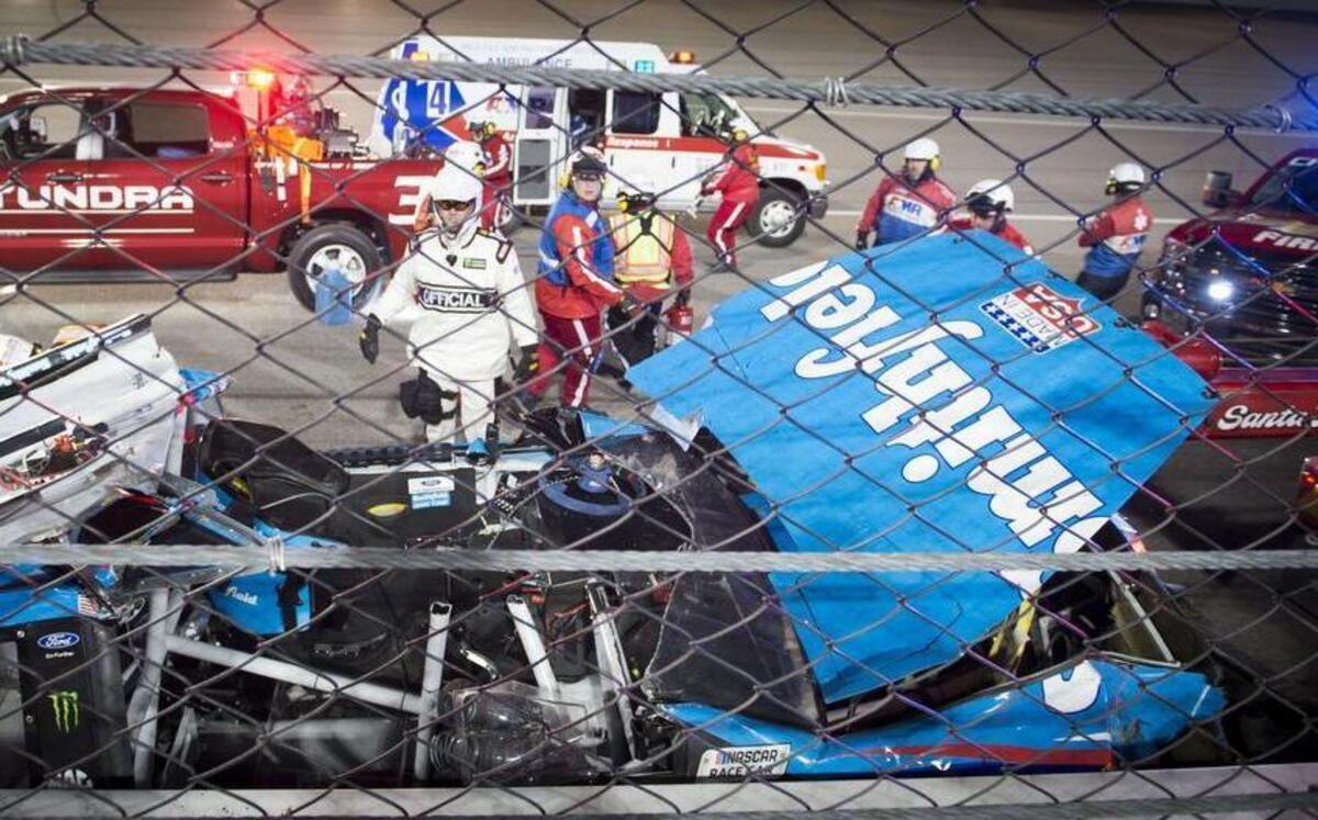 Emergency crews tend to the wreckage on the backstretch after Monster Energy NASCAR Cup Series driver Aric Almirola was pulled from the car after colliding with Joey Logano and Danica Patrick during the Go Bowling 400 at Kansas Speedway on Saturday, May 13, 2017, in Kansas City, Kansas.