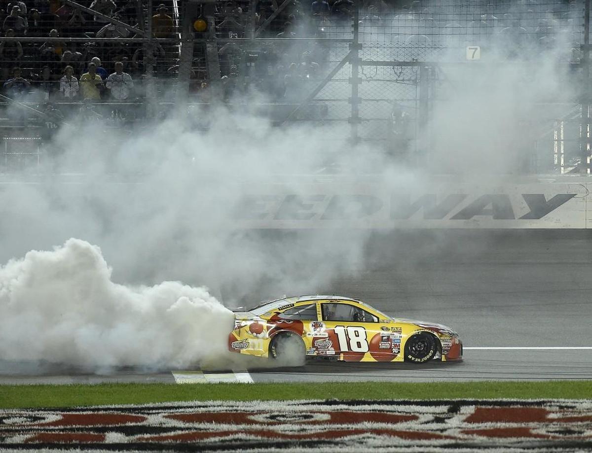 Driving his long-familiar M&M’s car, NASCAR motorsports racer Kyle Busch celebrated with a burnout after winning another one at Kansas Speedway in Kansas City, Kansas.