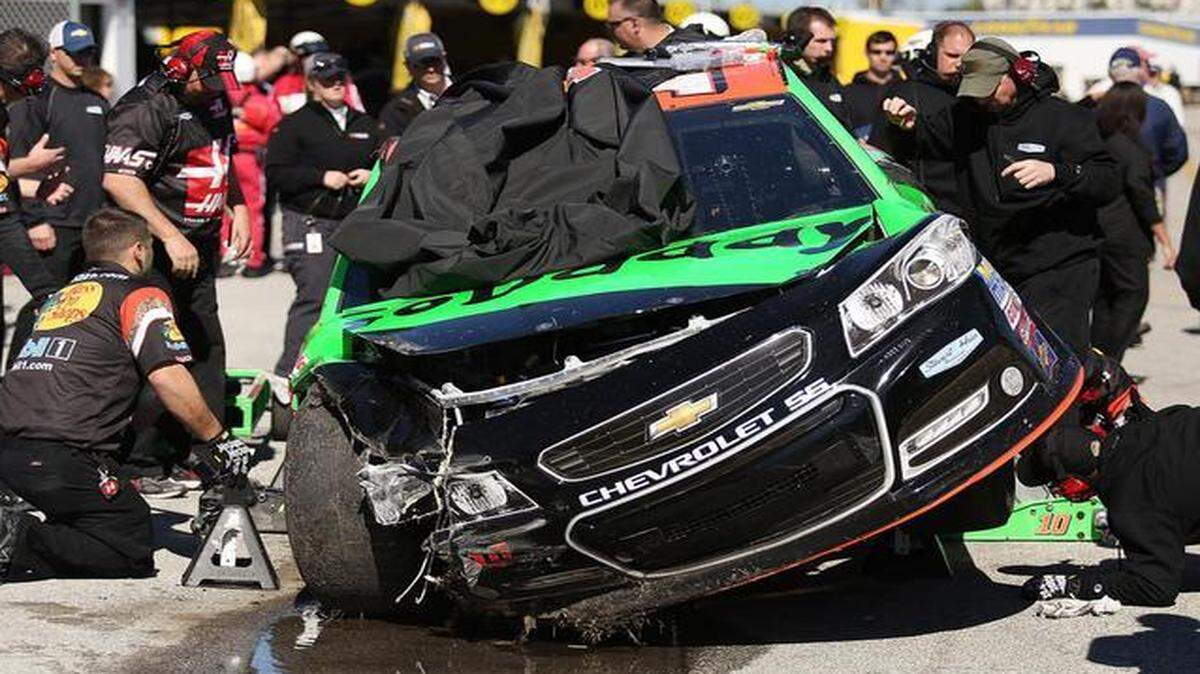 
Danica Patrick’s crew looks over her wrecked NASCAR Sprint Cup race car after she crashed during Daytona 500 practice Wednesday at Daytona International Speedway in Daytona Beach, Fla.

