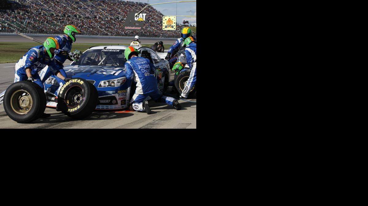 
The pit crew for NASCAR Sprint Cup Series driver Danica Patrick works on her car along pit road during the Hollywood Casino 400 auto race at Kansas Speedway in Kansas City, Kan., Sunday, Oct. 5
