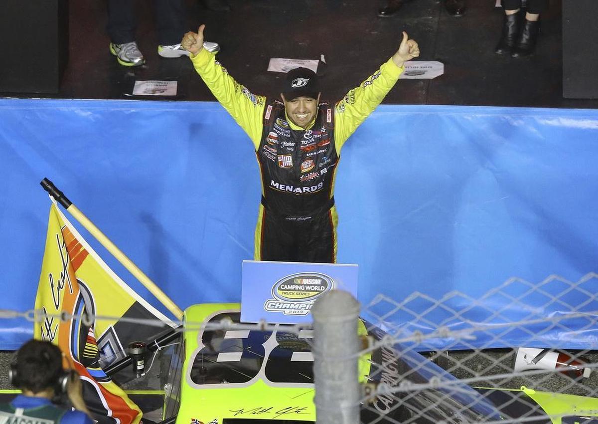 Matt Crafton celebrates after winning the NASCAR Trucks series season title Friday, Nov. 14, 2014, in Homestead, Fla. (AP Photo/David Graham)