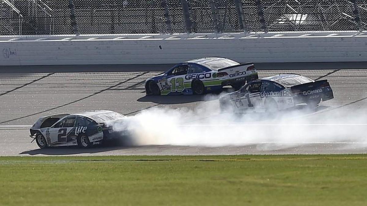 Brad Keselowski (No. 2 car, front left) got pushed by Denny Hamlin and spun out into the grass, knocking him out of the race on Sunday at Kansas Speedway.