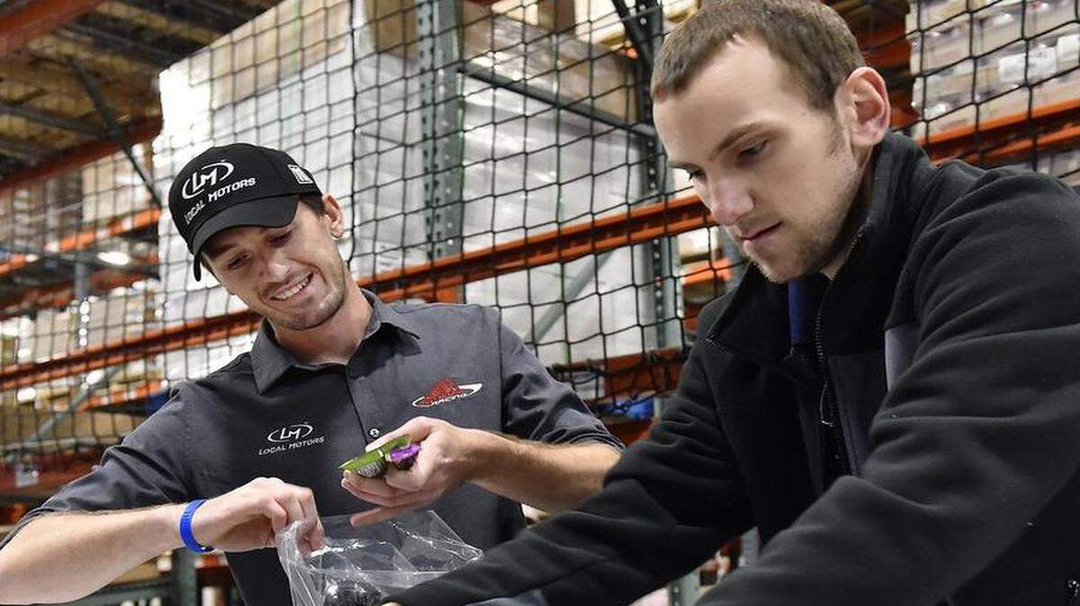 
NASCAR Camping World Truck Series driver Ben Kennedy (left) assisted Stephen Barnt and other Kansas Speedway employees in filling bags for Harvesters last month. Kennedy is back at the track for this weekend’s Toyota Tundra 250. 
