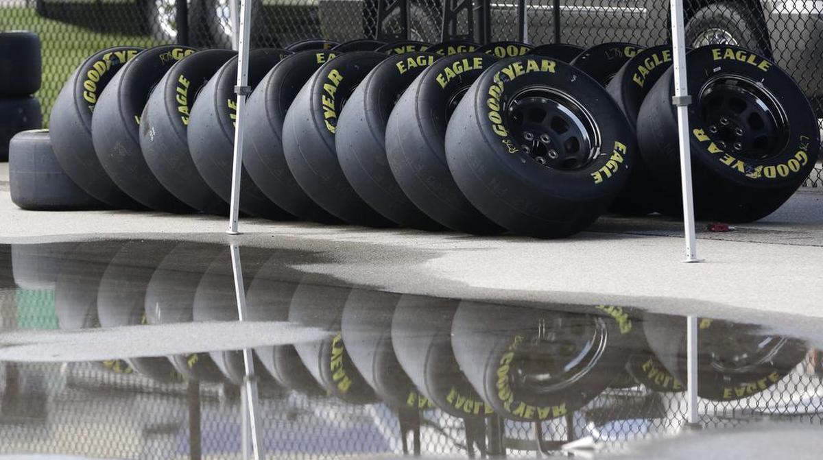 Race tires were stacked next to a rain puddle at Kansas Speedway in Kansas City, Kan., on Thursday. Wet weather is expected over the weekend. 