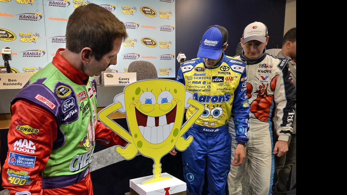 
NASCAR Sprint Cup drivers Greg Biffle (left) and David Ragan (second from right) checked out the trophy that goes to the winner of the SpongeBob SquarePants 400 on Saturday night at Kansas Speedway.
