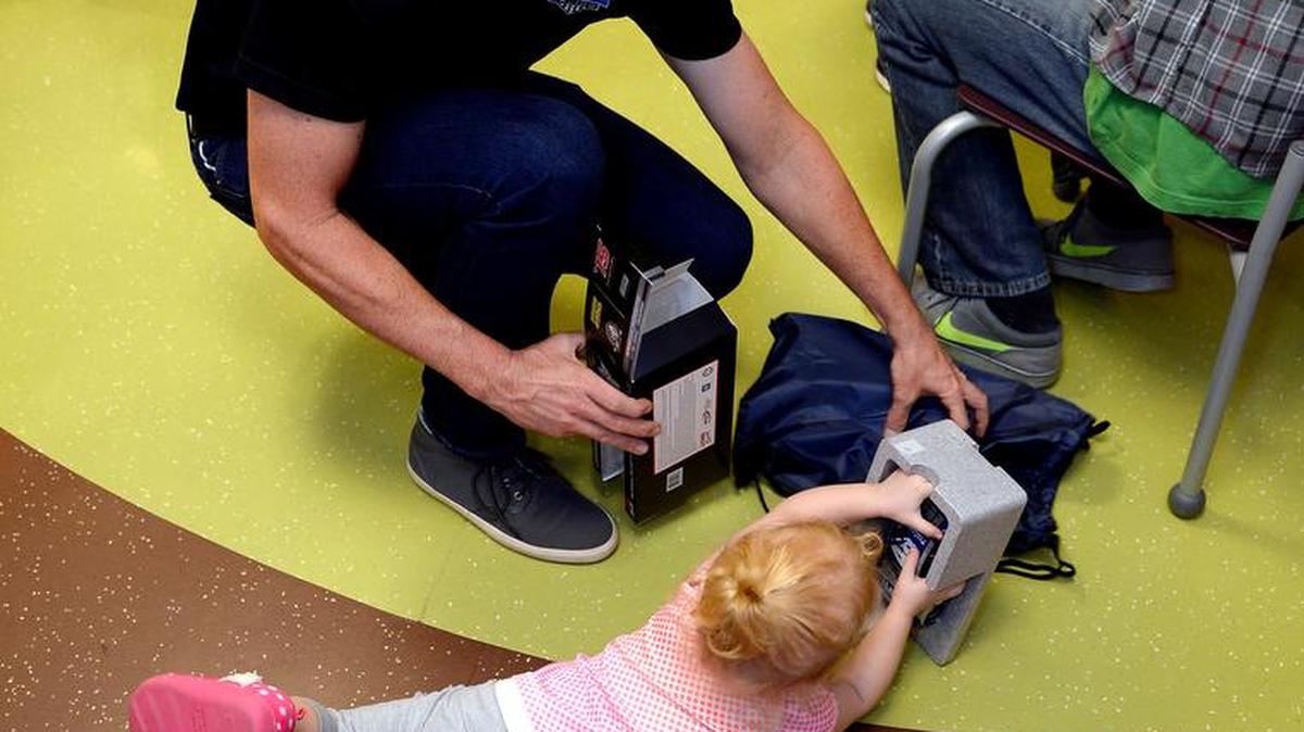 
NASCAR driver Jimmie Johnson visited patients in the pediatric unit of the University of Kansas Hospital on Tuesday and handed out gifts. Two-year-old Kiera White of Overland Park tried to get a model of Johnson's NASCAR car out of the packaging.

