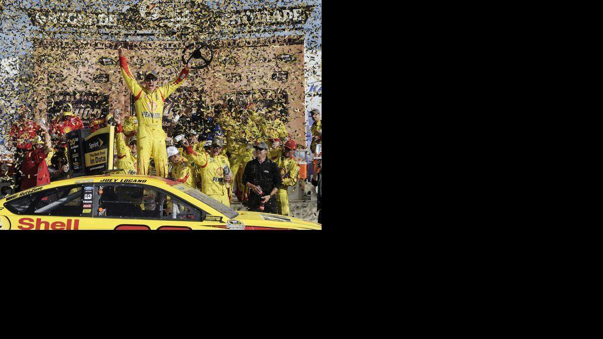 
Sprint Cup Series driver Joey Logano celebrates winning the 14th Annual Hollywood Casino 400 Sunday, October 5, 2014 at the Kansas Speedway.
