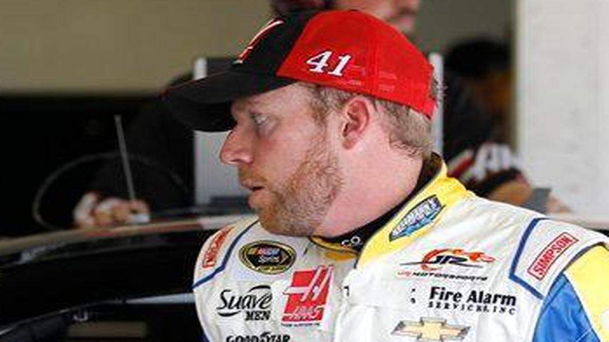 
Regan Smith walked past Kurt Busch’s car during practice Saturday for the Daytona 500. Smith will be replacing Busch in the car for the race.


