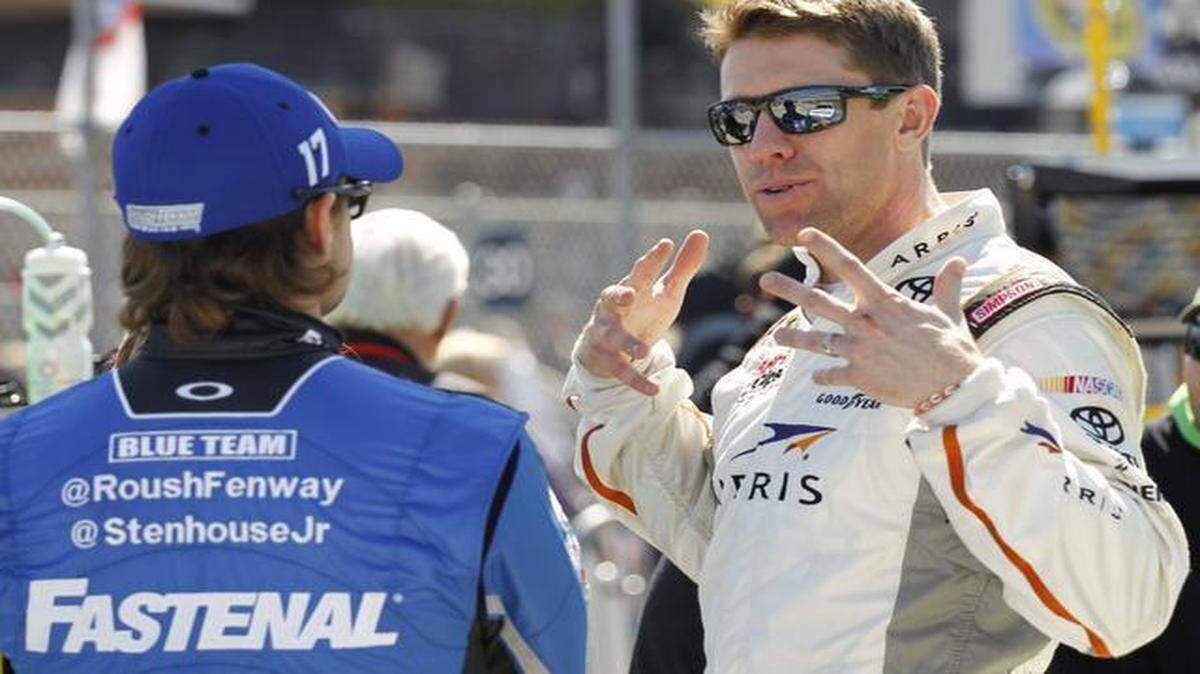 
Carl Edwards (right) appears excited to be a new part of Joe Gibbs Racing.
