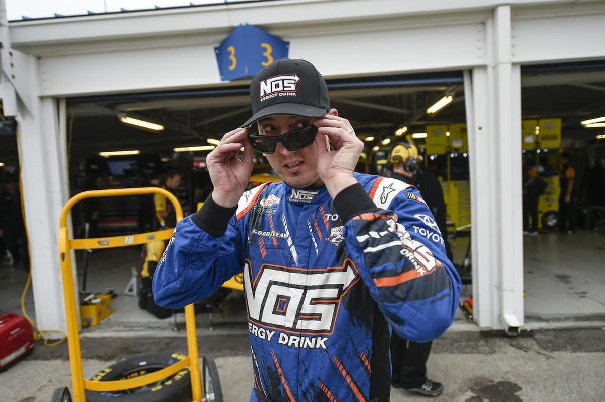 Kyle Busch slips on his sunglasses after a Saturday morning practice session at Kansas Speedway ahead of the 2016 Hollywood Casino 400.