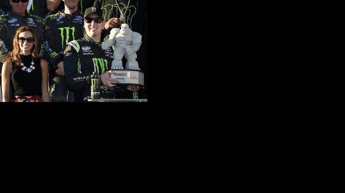 
Kyle Busch, right, poses with the trophy next to his wife Samantha, left, in Victory Lane after he won the NASCAR Nationwide series auto race Saturday at Dover International Speedway in Dover, Del. 
