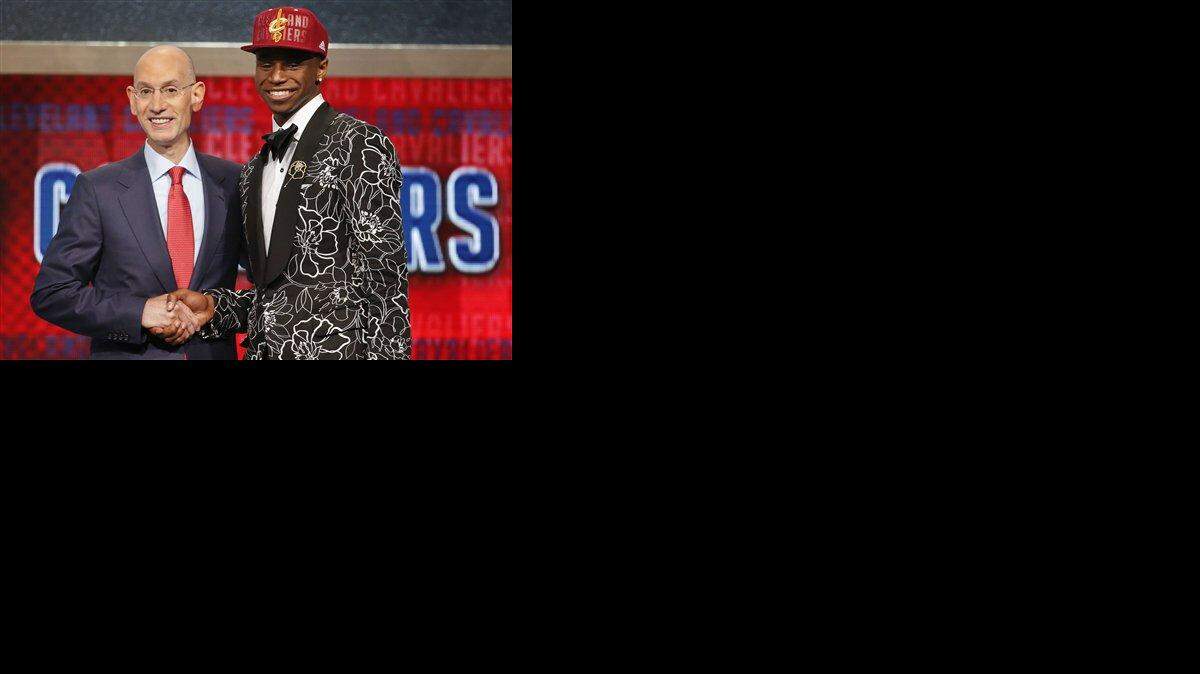 NBA Commissioner Adam Silver, left, congratulates Andrew Wiggins of Kansas who was selected by the Cleveland Cavaliers as the number one pick in the 2014 NBA draft, Thursday, June 26, 2014, in New York.