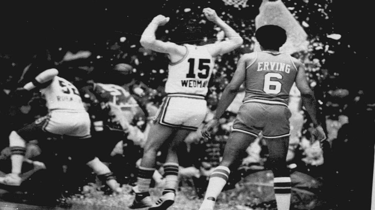 
This Nov. 1979, file photo shows the Kansas City Kings’ Scott Wedman and Philadelphia 76ers star Julius Erving watching as the Kings’ Bill Robinzine (left) and 76ers’ Darryl Dawkins ran for cover after Dawkins shattered the glass backboard during a basketball game at Municipal Audtorium.
