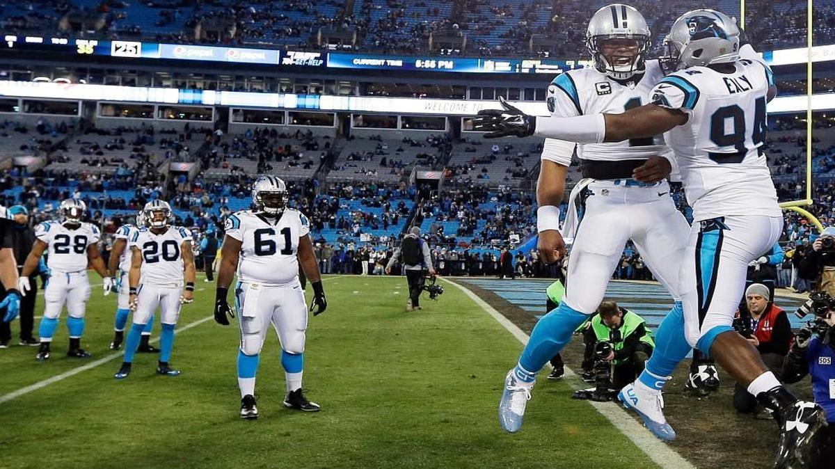 Defensive end Kony Ealy (94) and quarterback Cam Newton bumped chests before the Carolina Panthers faced the Arizona Cardinals in the NFC Championship on Sunday in Charlotte, N.C. The Panthers beat the Cardinals 49-15 to advance to Super Bowl 50, where they will play the AFC champion Denver Broncos.