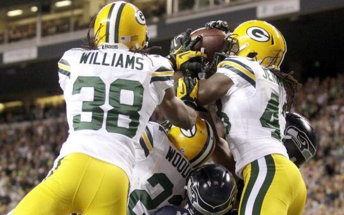 
The Green Bay Packers’ Tramon Williams (38) and Charles Woodson (21) vied for a pass against the Seattle Seahawks’ Charly Martin (14), M.D. Jennings and Golden Tate (obscured) in the final moments of the Monday Night Football game on Sept. 24, 2012, in Seattle. After review, the play stood as a touchdown by the Seahawks’ Golden Tate as the Seahawks won 14-12.
