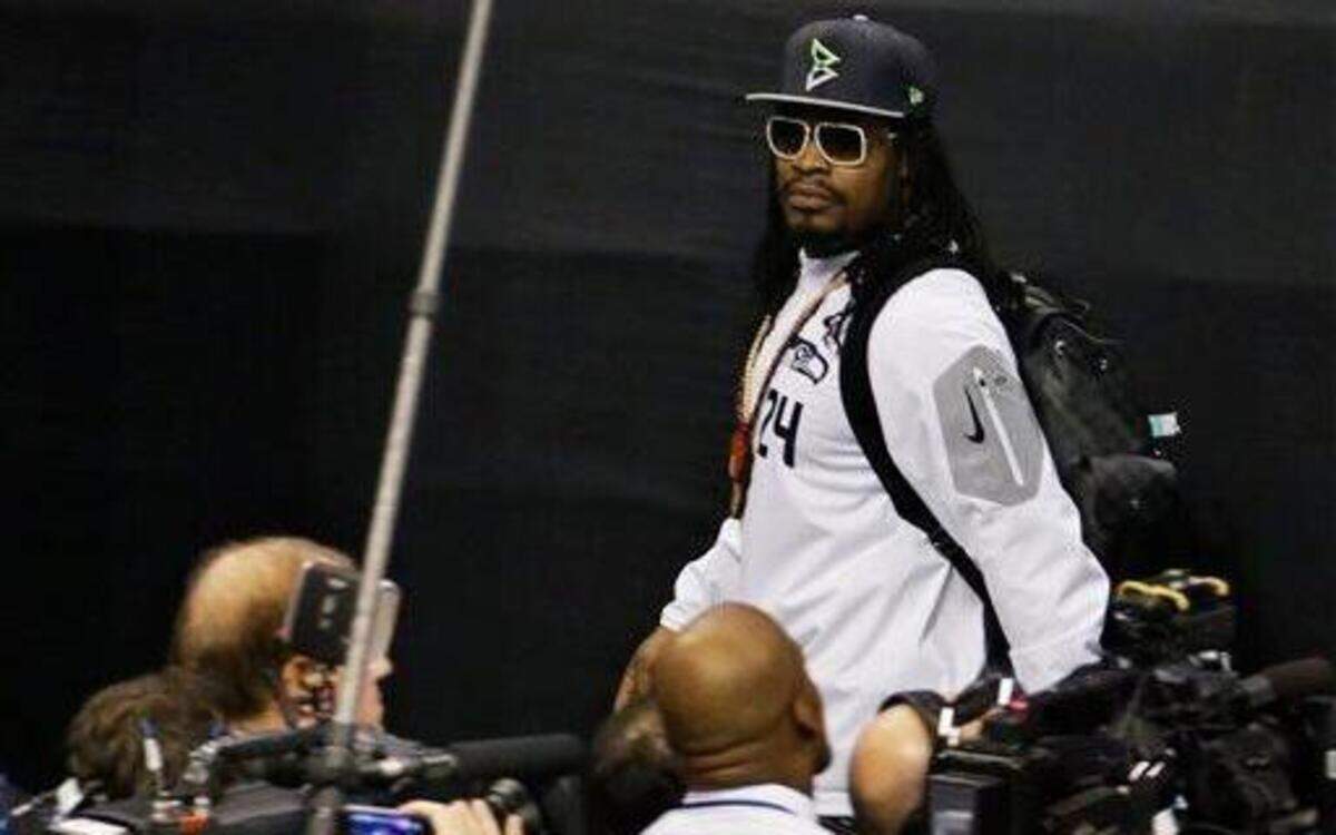 
Seattle Seahawks running back Marshawn Lynch walked past reporters as he left Super Bowl XLIX Media Day on Tuesday at US Airways Center in Phoenix.
