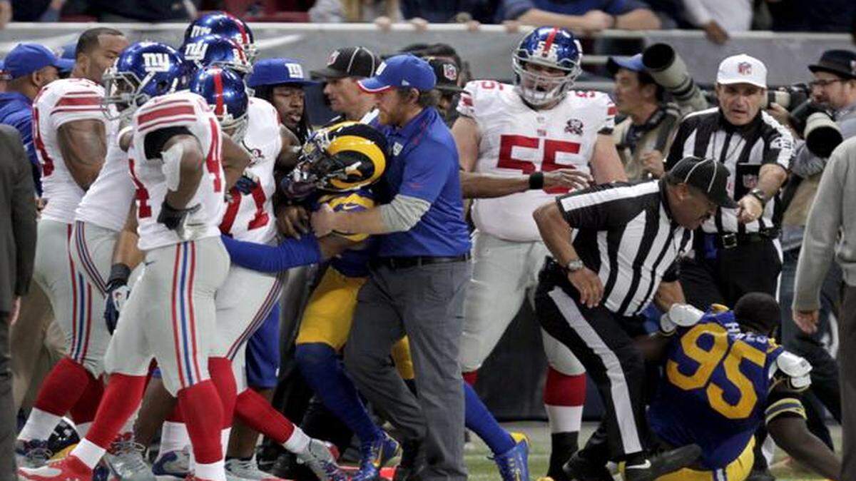 
Members of the St. Louis Rams and the New York Giants fought on the sideline during the first half on Sunday in St. Louis.
