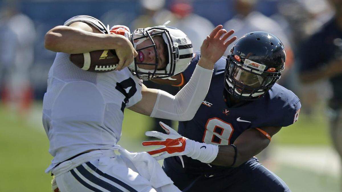 
Virginia safety Anthony Harris tackled Brigham Young quarterback Taysom Hill on Sept. 20 in Provo, Utah. 
