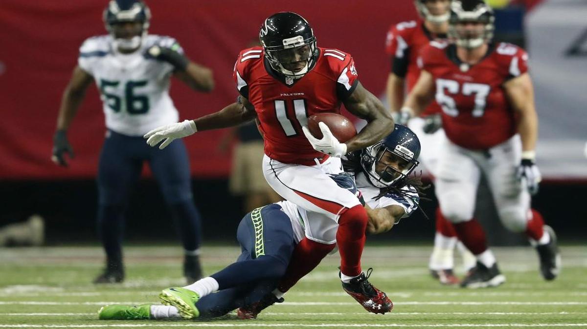 Seahawks cornerback Richard Sherman (25) tackles Falcons wide receiver Julio Jones (11) during the second half Jan. 14 in Atlanta.