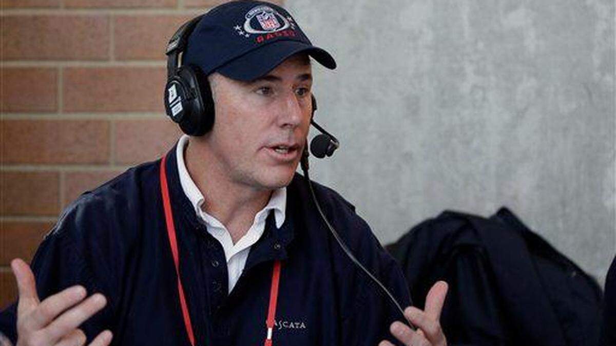 Rich Gannon conducts an interview at the NFL football scouting combine in Indianapolis, Thursday, Feb. 19, 2015. (AP Photo/David J. Phillip)