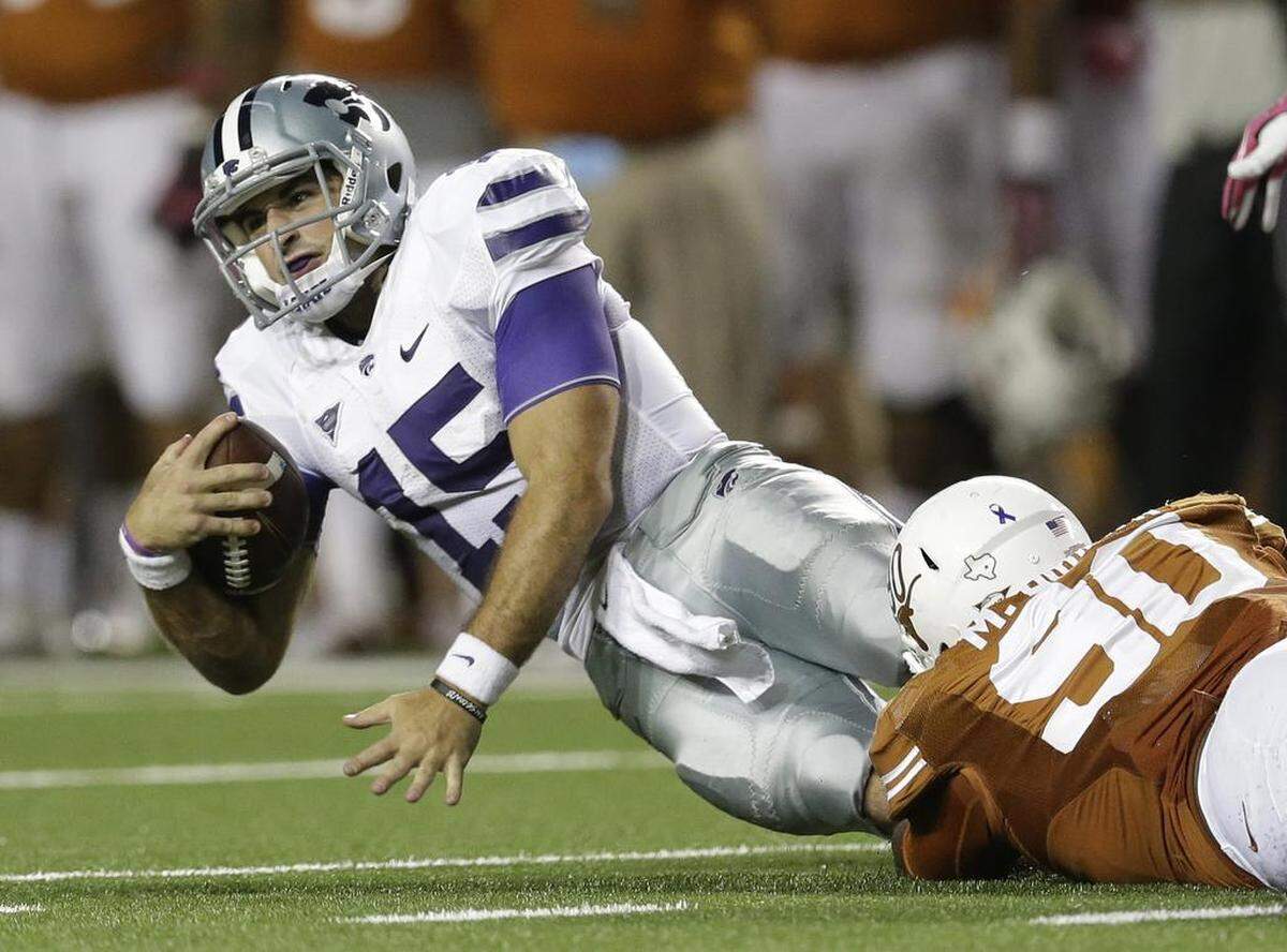 Kansas State’s Jake Waters was taken down by Texas’ Malcom Brown on Saturday, Sept. 21, 2013, in Austin, Texas.